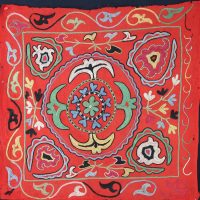 colourful motifs on a vibrant red woollen cloth