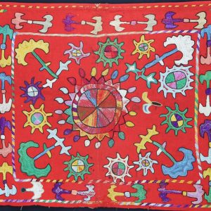 colourful motifs on a vibrant red woollen cloth