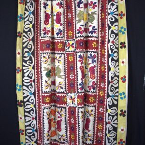 applique rabbits and ducks with embroidered flowers cover this curtain.