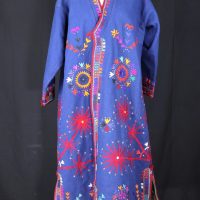 blue felt long jacket covered in colourful geometric designs with stars and floral type motifs.