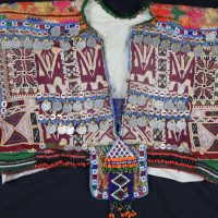 Colourful traditional embroidered garment with coins