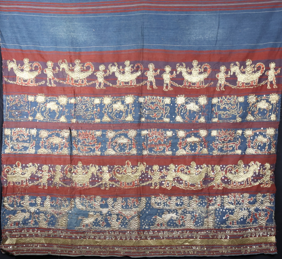 Colourful traditional textile with gold design patterns