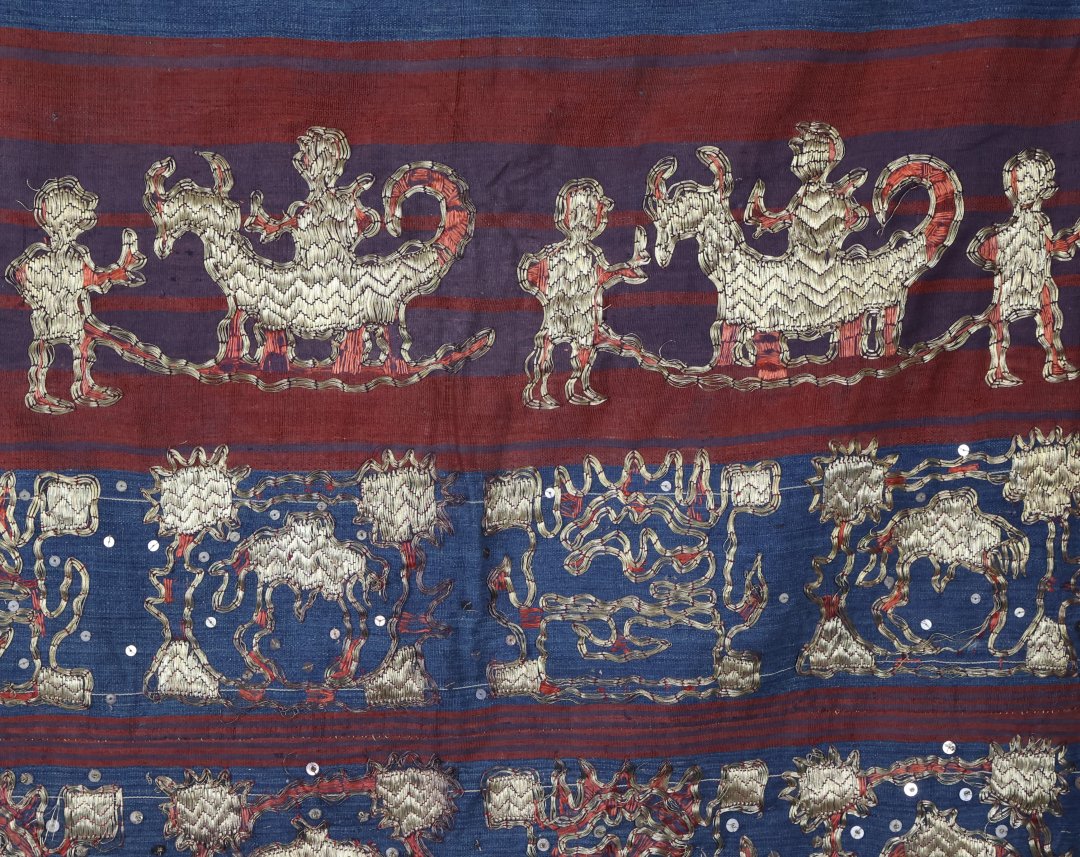 Colourful traditional textile with gold design patterns