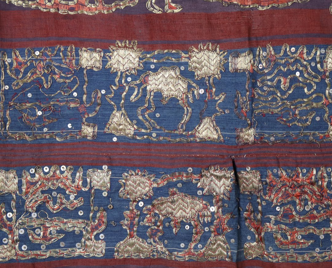 Colourful traditional textile with gold design patterns