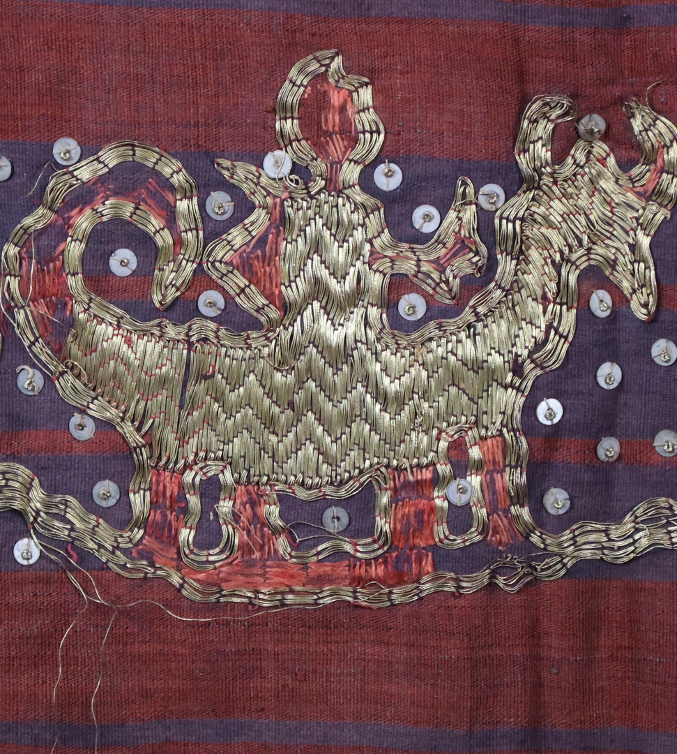 Colourful traditional textile with gold design patterns