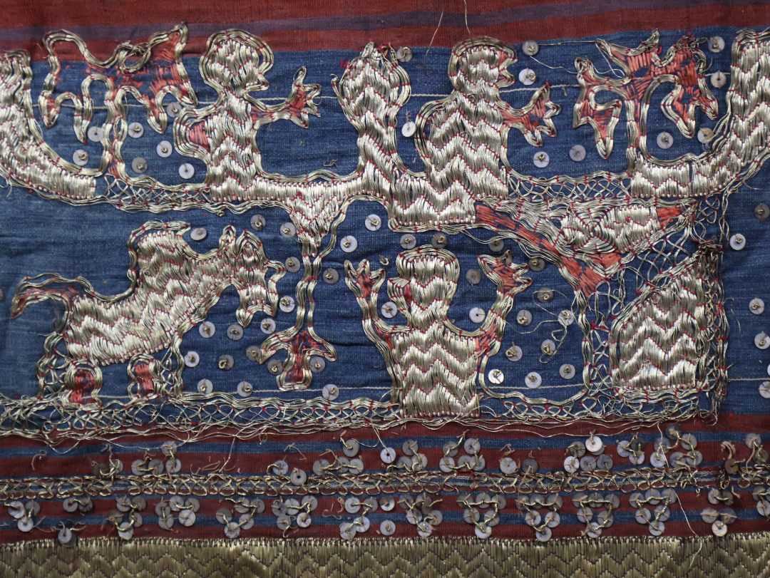 Colourful traditional textile with gold design patterns