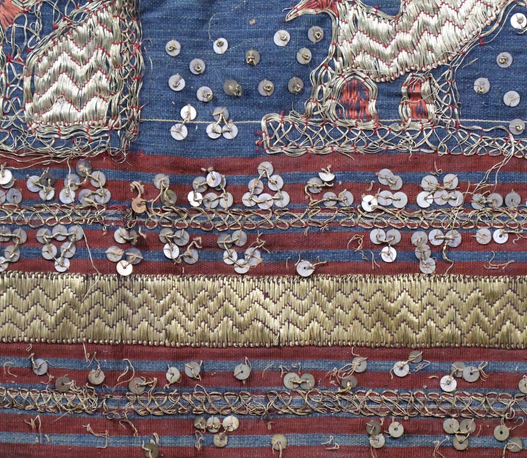 Colourful traditional textile with gold design patterns