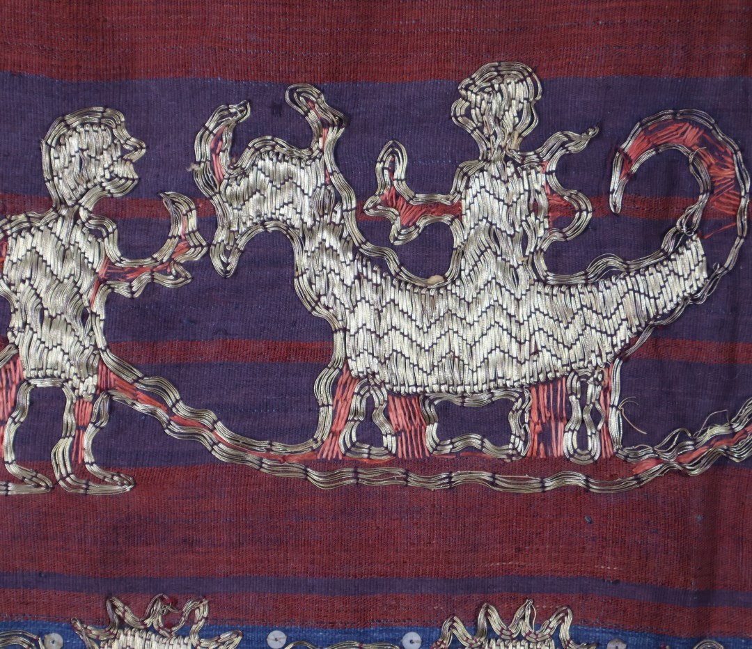 Colourful traditional textile with gold design patterns