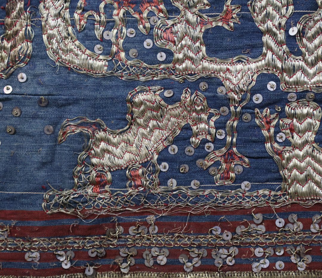 Colourful traditional textile with gold design patterns