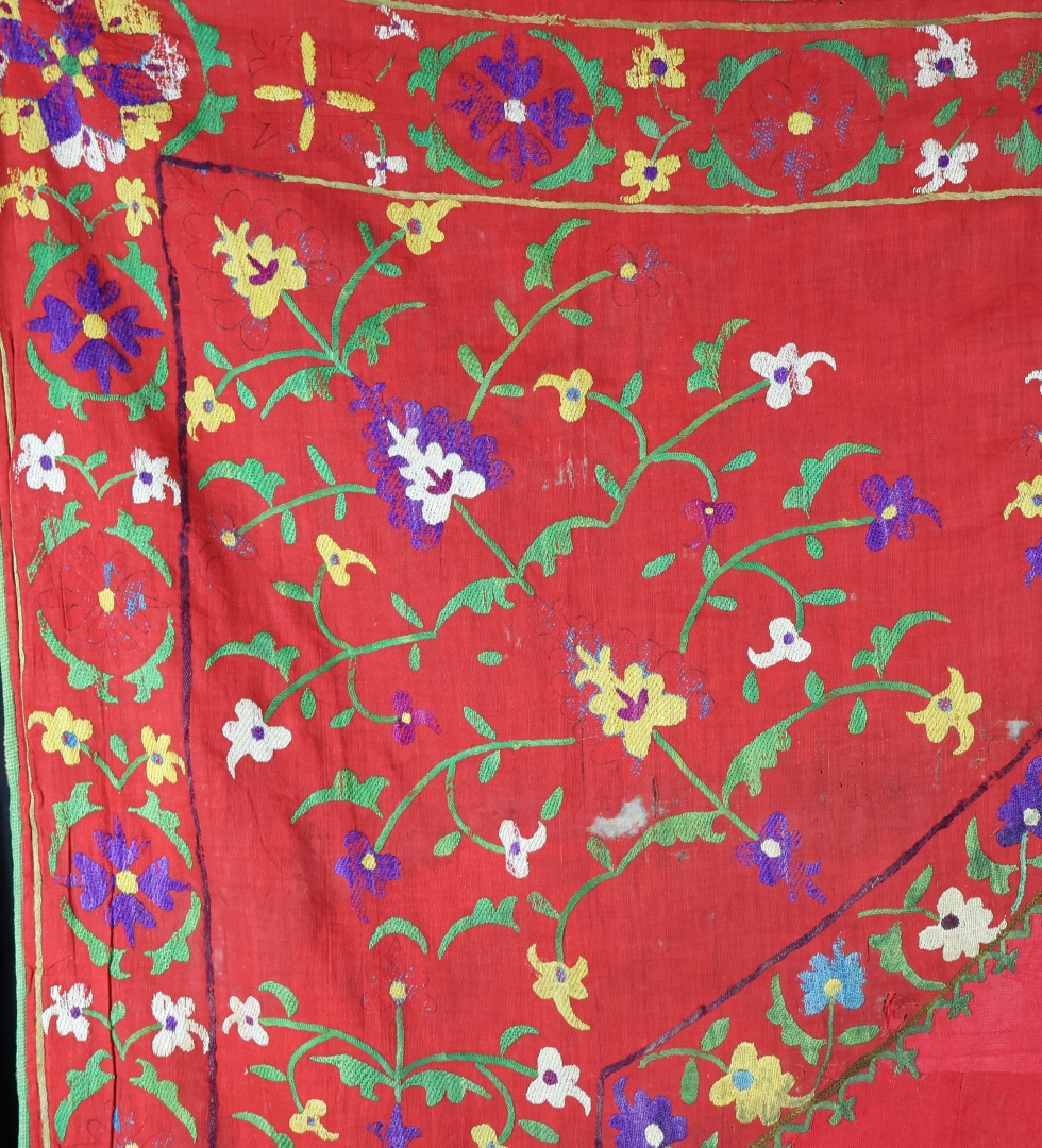 Vibrant embroidered textile with floral patterns.