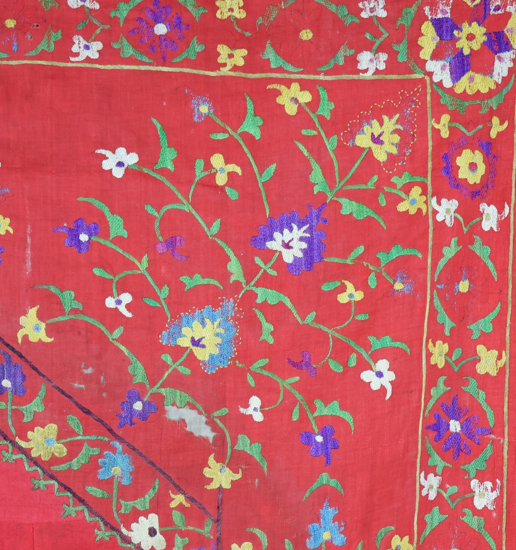 Vibrant embroidered textile with floral patterns.