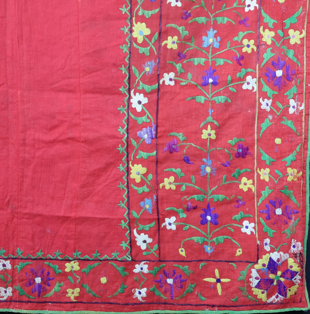 Vibrant embroidered textile with floral patterns.