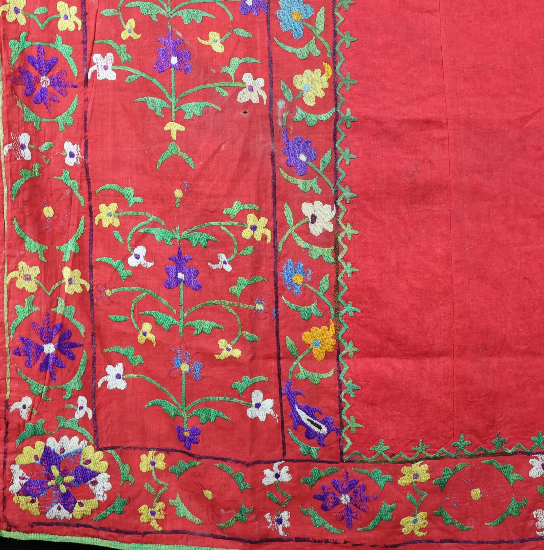 Vibrant embroidered textile with floral patterns.