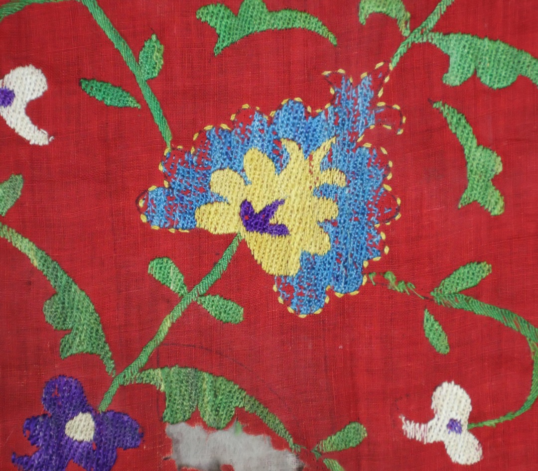 Vibrant embroidered textile with floral patterns.