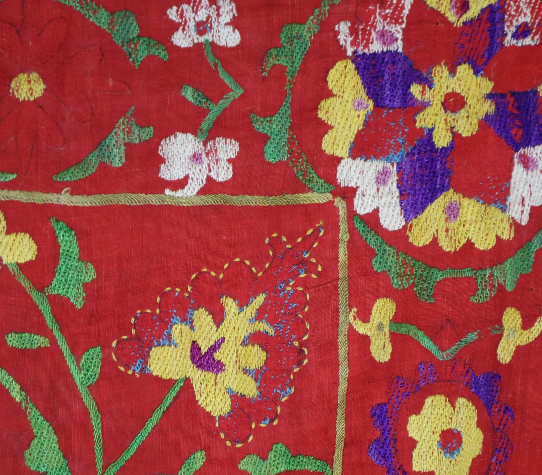 Vibrant embroidered textile with floral patterns.