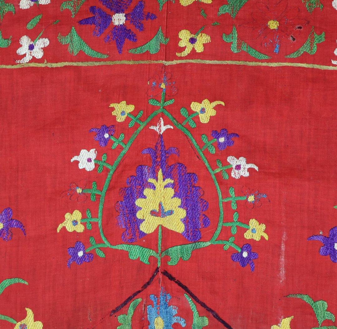 Vibrant embroidered textile with floral patterns.