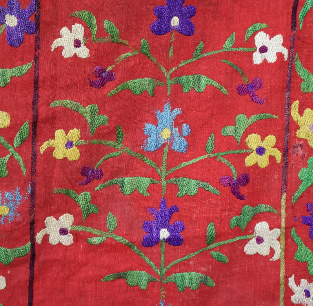 Vibrant embroidered textile with floral patterns.
