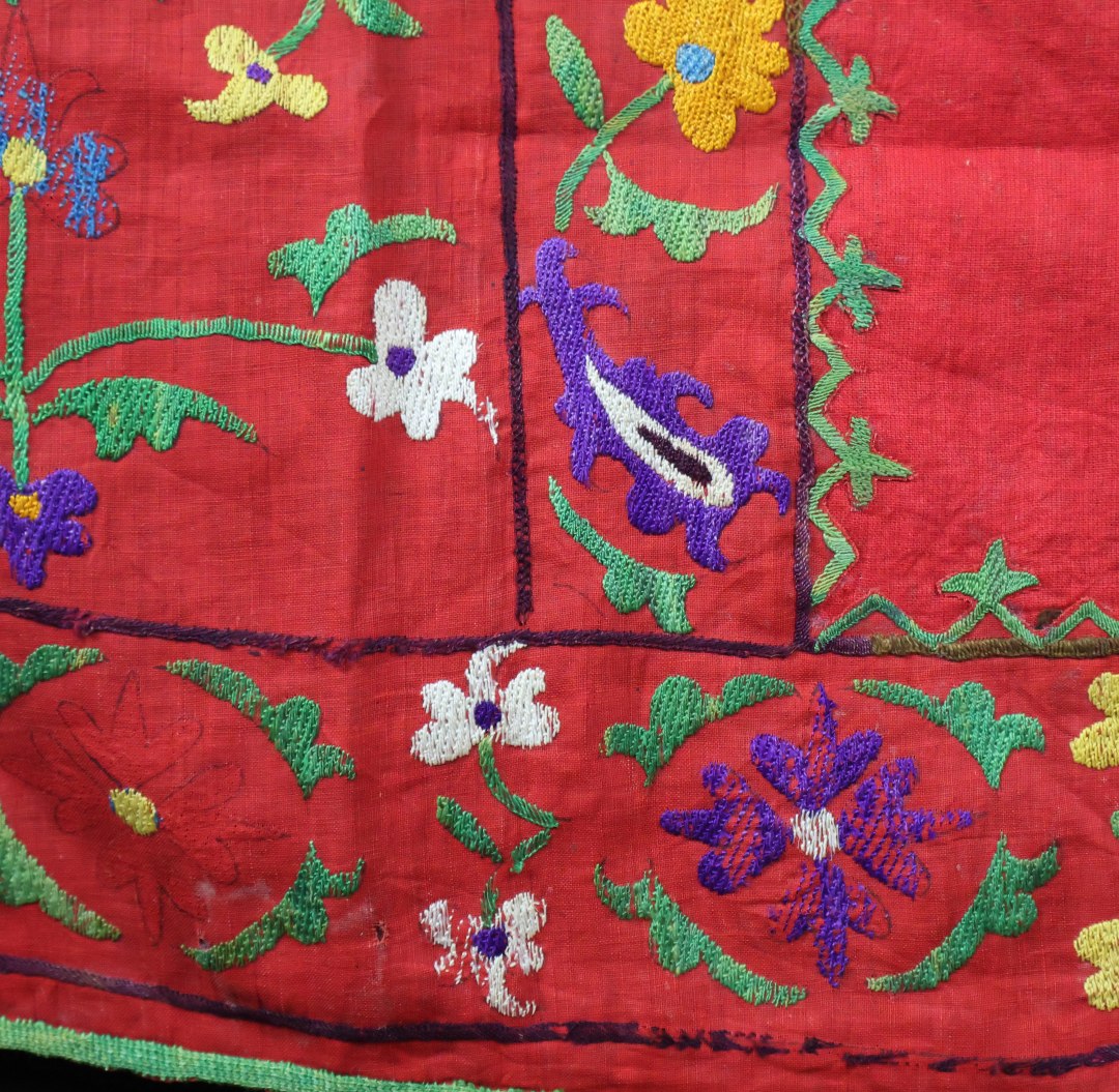 Vibrant embroidered textile with floral patterns.
