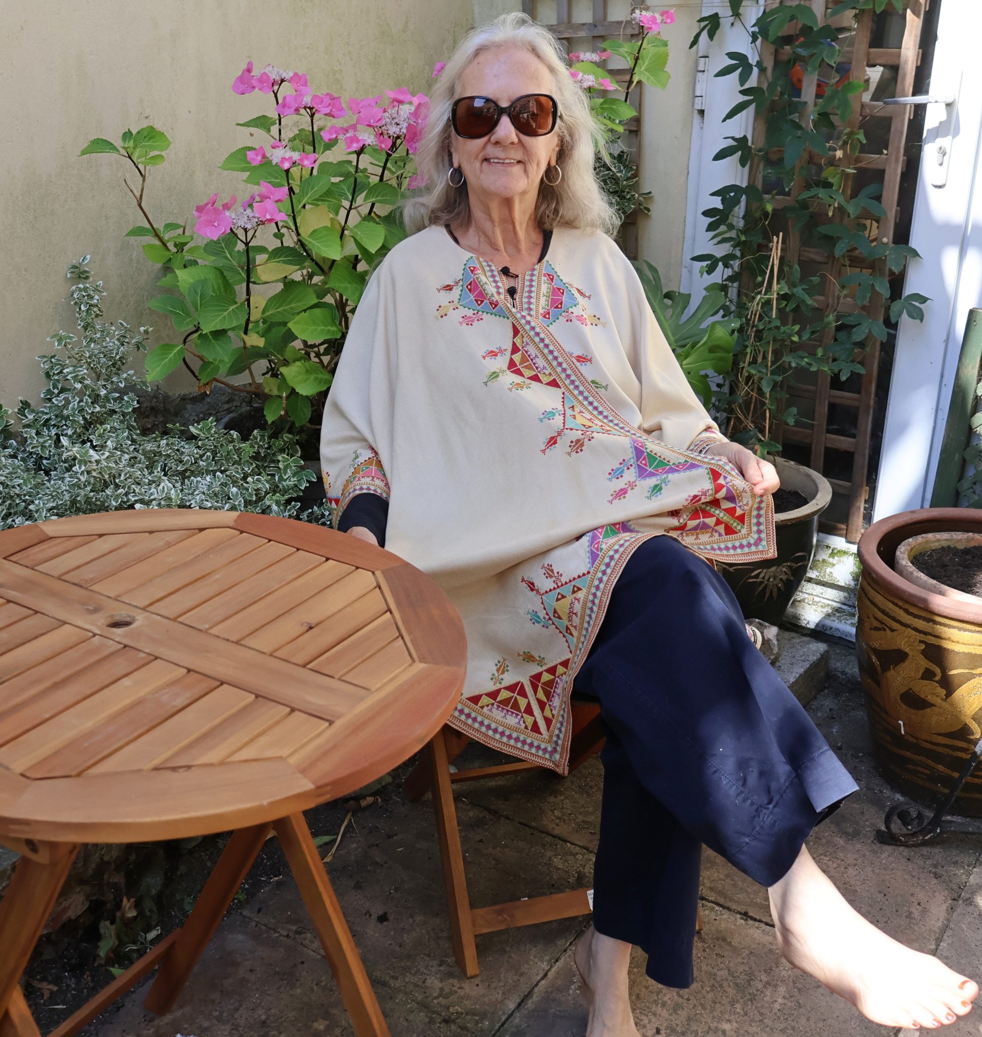woman wearing embroidered poncho.