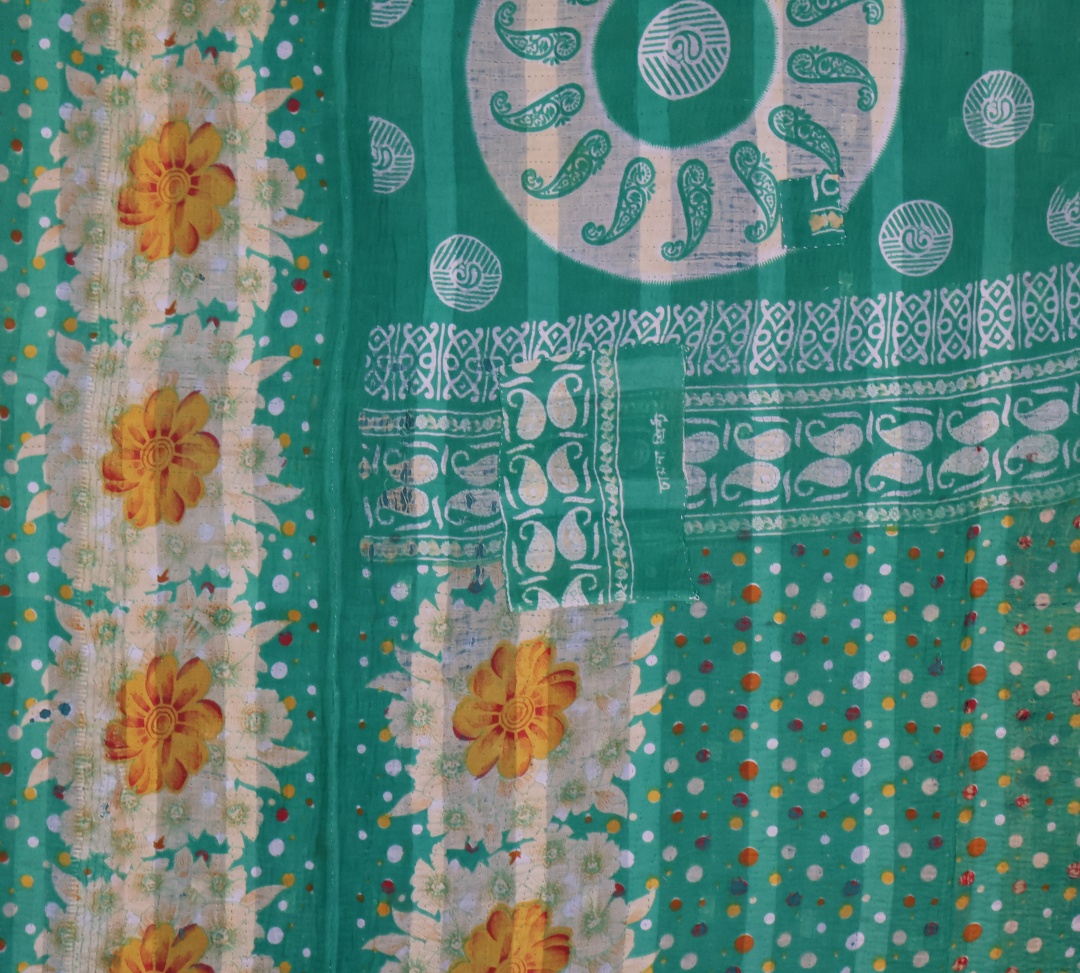 Vibrant green fabric with floral patterns